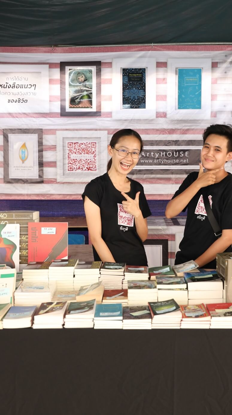 Thai booth staff pose for a photo